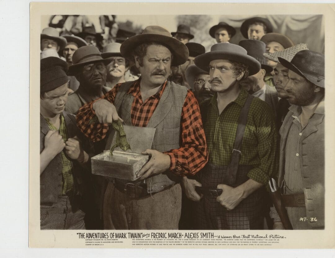 A group of men in old-fashioned attire, one holding a box.